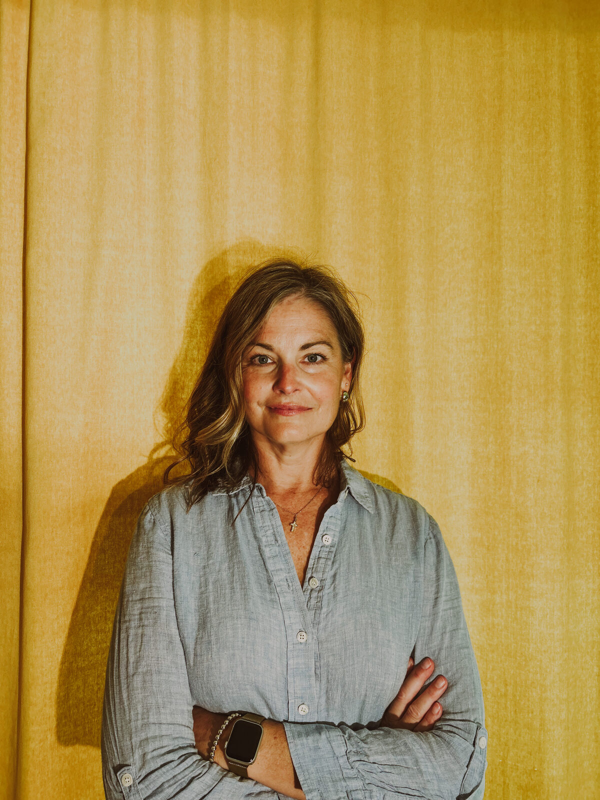 Julia Pickerill beside a gold curtain